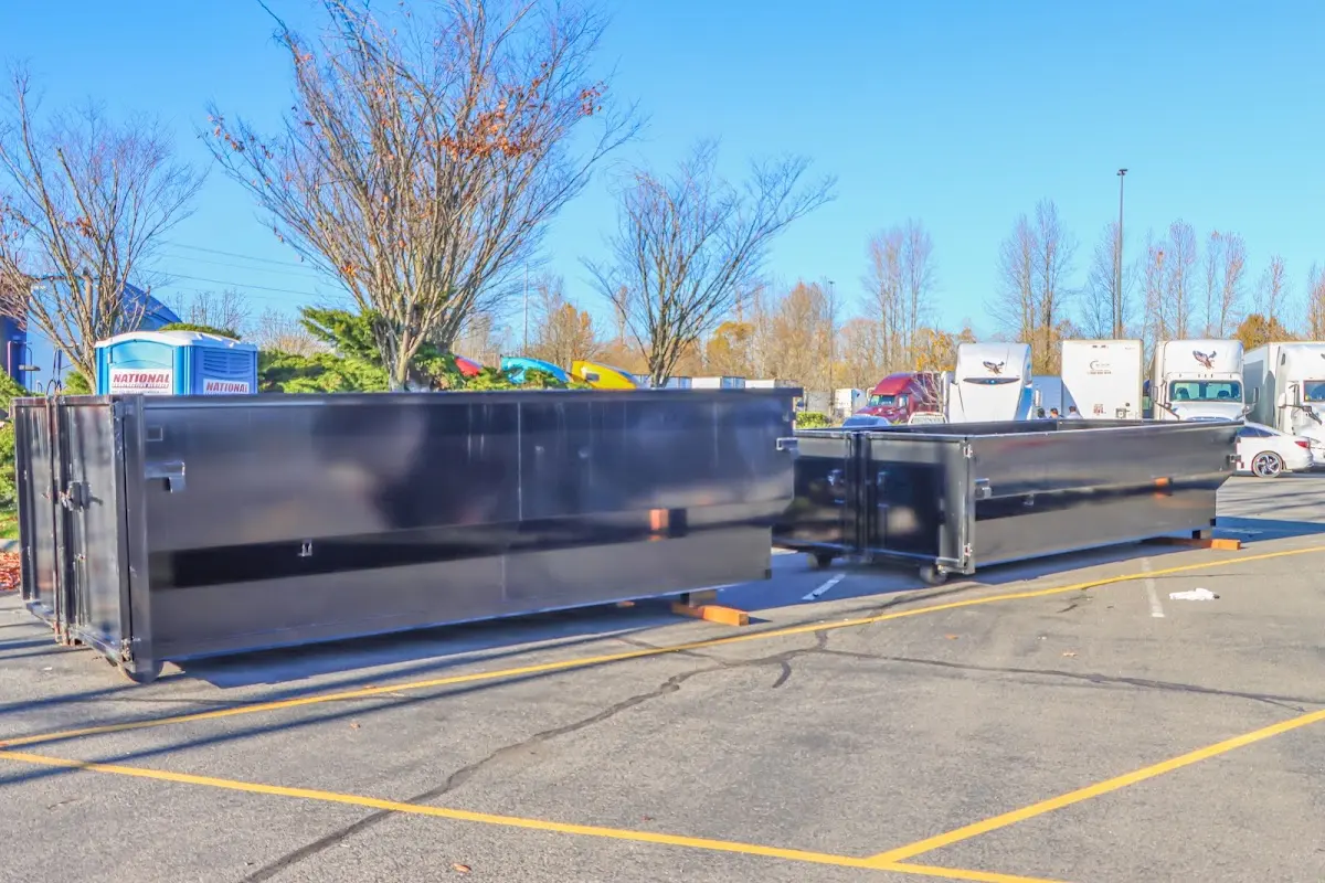 Professional dumpster rental service with roll-off container on residential driveway in Timberwood Park